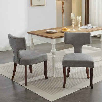 Ensemble de 2 chaises de salle à manger, assise rembourrée en lin, dossier incurvé orné de clous en cuivre, structure en bois massif.
